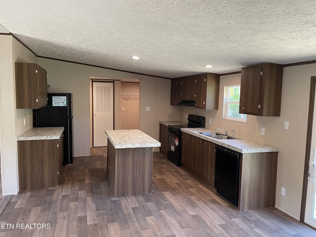 kitchen featuring a center island, dark wood-style floors, a sink, and black appliances