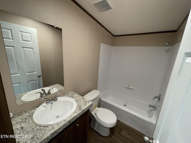 full bathroom featuring wood finished floors, vanity, shower / washtub combination, toilet, and visible vents