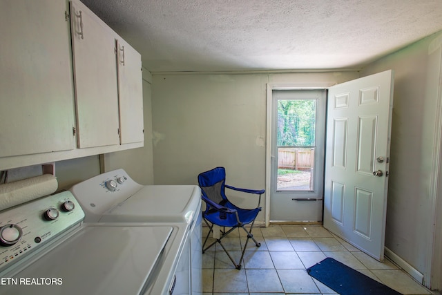124 E Wadsworth Cir, Oak Ridge, TN 37830 - clothes washing area with a textured ceiling, cabinet space, light tile patterned floors, and washer and dryer