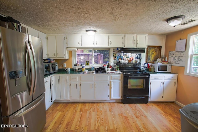 124 E Wadsworth Cir, Oak Ridge, TN 37830 - kitchen featuring white cabinets, stainless steel appliances, light wood-type flooring, under cabinet range hood, and visible vents