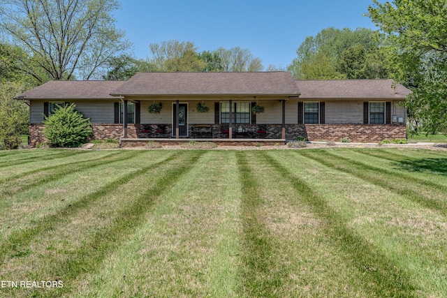 ranch-style home with brick siding, a porch, and a front yard