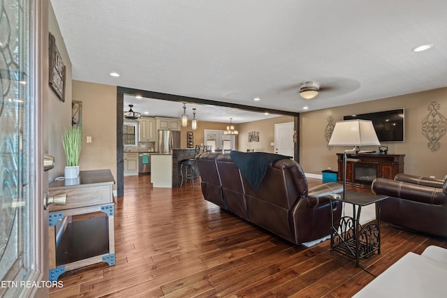 living room featuring recessed lighting, ceiling fan, and dark wood-type flooring