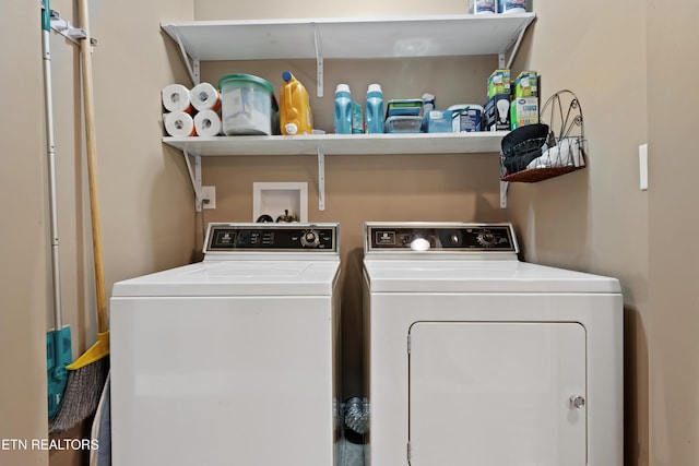 washroom with independent washer and dryer and laundry area