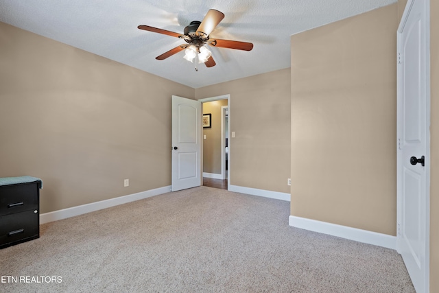 unfurnished bedroom with baseboards, a ceiling fan, and carpet floors