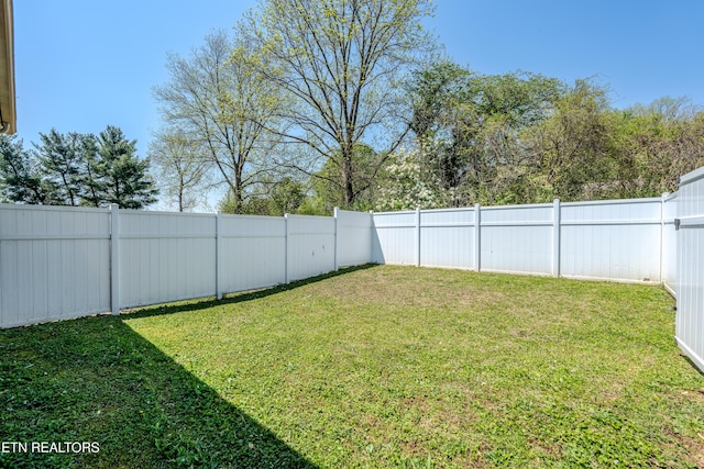 view of yard with a fenced backyard