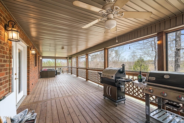 deck with ceiling fan, a grill, and an outdoor living space