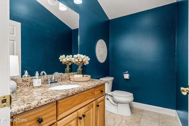 bathroom with baseboards, vanity, marble finish floor, and toilet