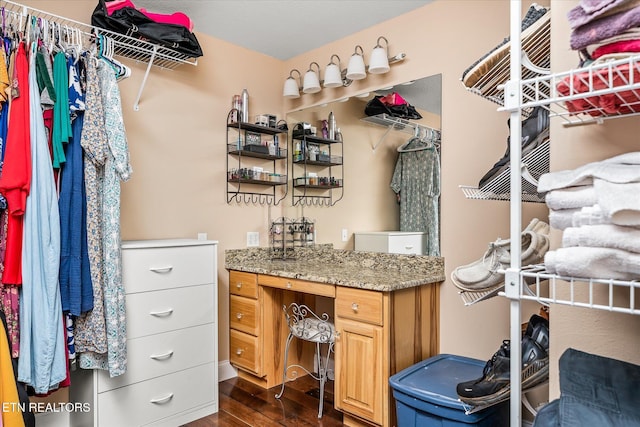 spacious closet with dark wood finished floors