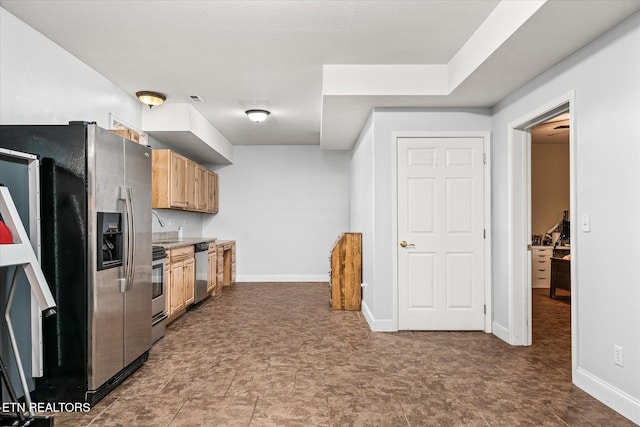 kitchen with light countertops, baseboards, light brown cabinets, and stainless steel appliances