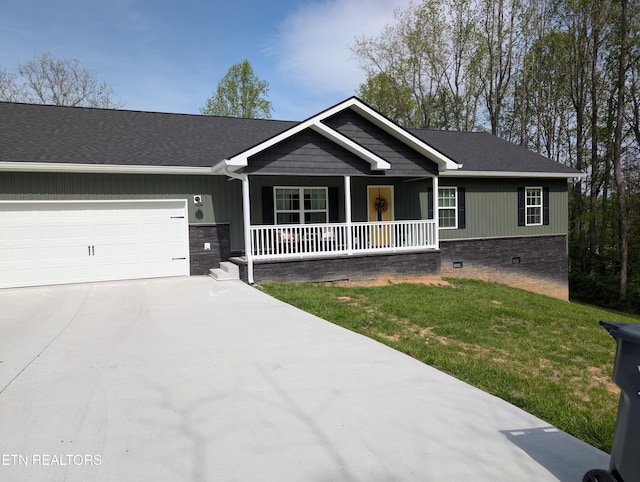 ranch-style house featuring crawl space, a front lawn, driveway, covered porch, and a garage