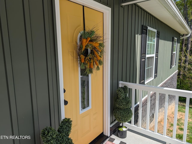 entrance to property featuring board and batten siding