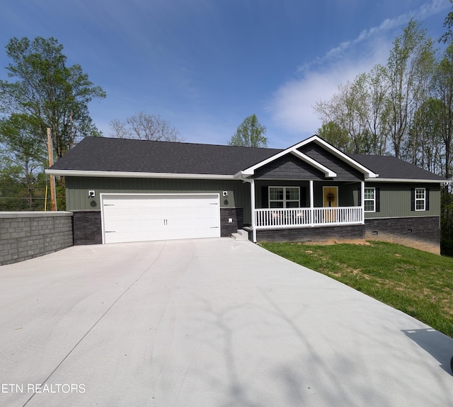view of front of property with an attached garage, crawl space, concrete driveway, and covered porch