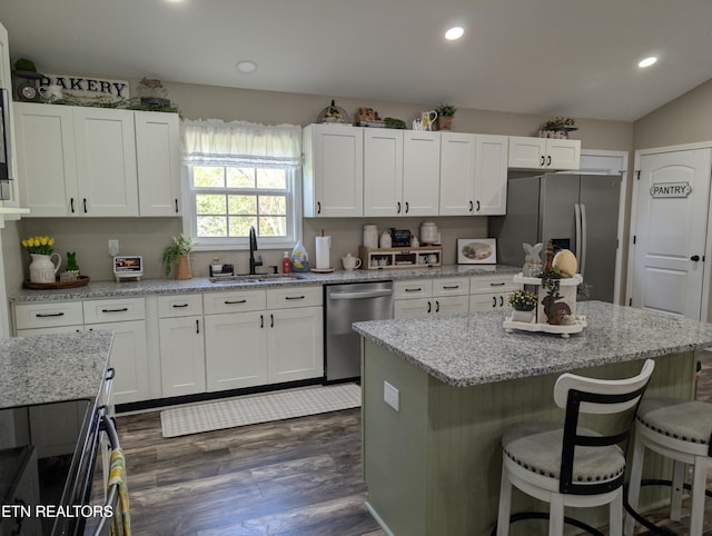 kitchen featuring white cabinets, appliances with stainless steel finishes, and a sink