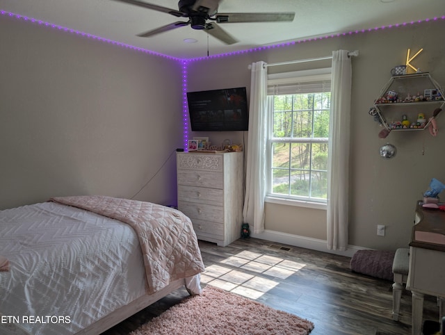 bedroom with baseboards, a ceiling fan, and wood finished floors