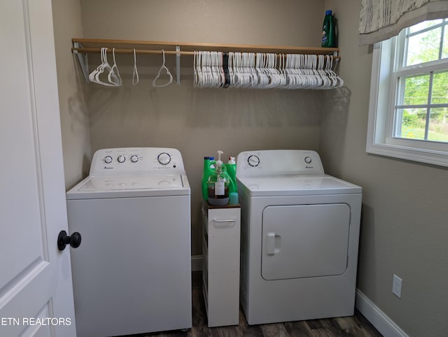 clothes washing area with washing machine and dryer, dark wood-type flooring, and laundry area