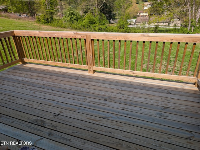 wooden terrace with a lawn