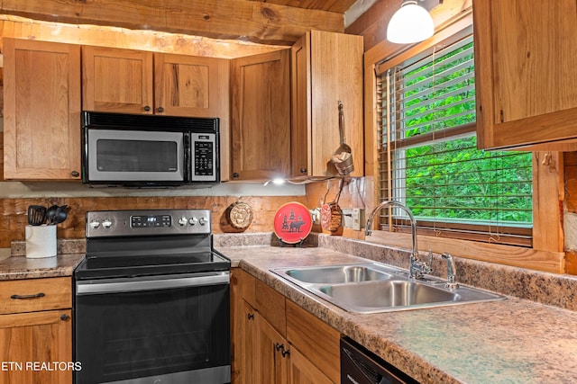 kitchen with a sink, stainless steel electric range oven, and light countertops