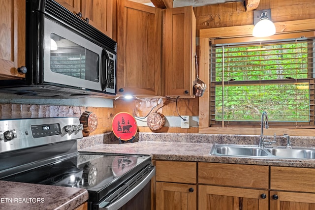 kitchen featuring a sink, stainless steel electric range oven, and brown cabinets