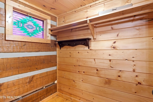 mudroom with wood walls