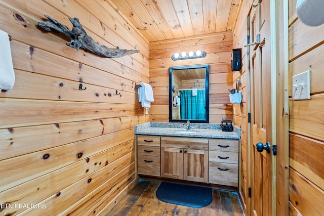 bathroom with wooden walls, vanity, wood ceiling, and hardwood / wood-style floors