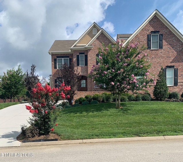 11969 Lakehurst Ln, Knoxville, TN 37934 - view of front facade featuring brick siding, a front lawn, and concrete driveway