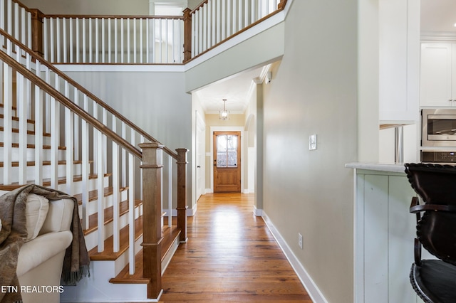 11969 Lakehurst Ln, Knoxville, TN 37934 - foyer entrance featuring wood finished floors, baseboards, stairway, a towering ceiling, and crown molding