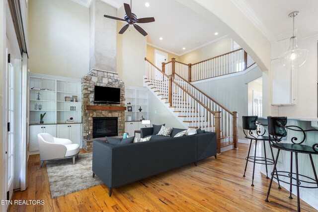 11969 Lakehurst Ln, Knoxville, TN 37934 - living room featuring a high ceiling, light wood finished floors, a ceiling fan, stairway, and a fireplace