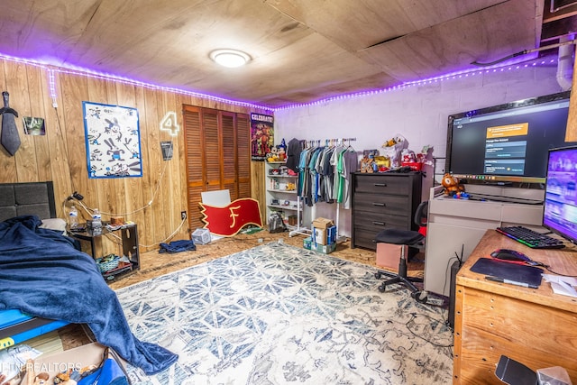 bedroom featuring wooden walls