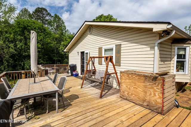 wooden deck featuring outdoor dining area