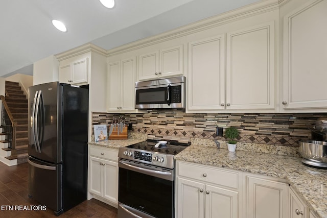 3317 Parrish Hill Ln, Knoxville, TN 37938 - kitchen with dark wood finished floors, cream cabinets, tasteful backsplash, and stainless steel appliances