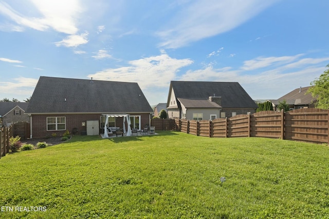 3317 Parrish Hill Ln, Knoxville, TN 37938 - back of property featuring a lawn, a fenced backyard, and a patio