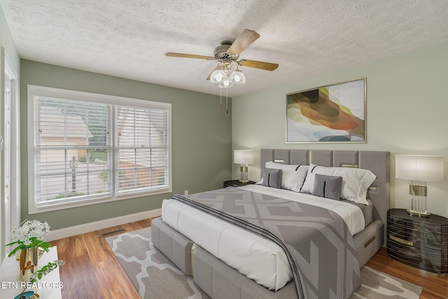 1109 Greywood Dr, Knoxville, TN 37923 - bedroom featuring wood finished floors, baseboards, a textured ceiling, and a ceiling fan