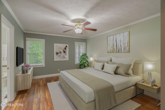 1109 Greywood Dr, Knoxville, TN 37923 - bedroom with wood finished floors, a textured ceiling, baseboards, crown molding, and ceiling fan