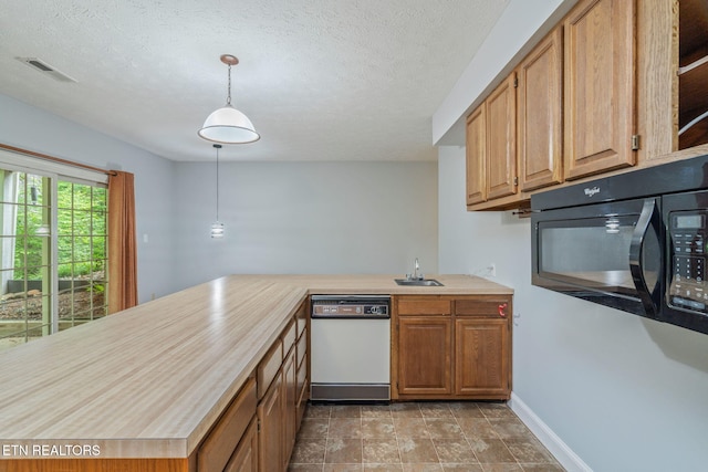 1109 Greywood Dr, Knoxville, TN 37923 - kitchen featuring white dishwasher, light countertops, a sink, black microwave, and a textured ceiling
