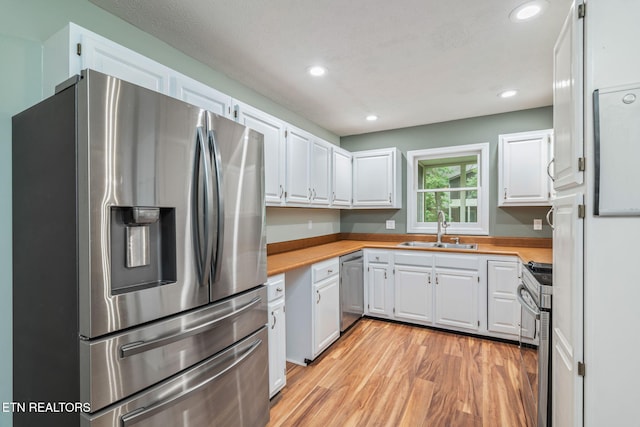1109 Greywood Dr, Knoxville, TN 37923 - kitchen featuring appliances with stainless steel finishes, a sink, light countertops, white cabinets, and recessed lighting