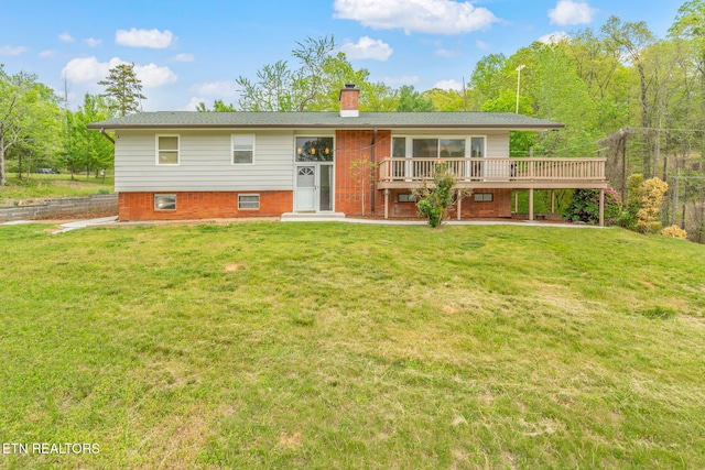 split foyer home featuring a chimney, a front yard, and a deck