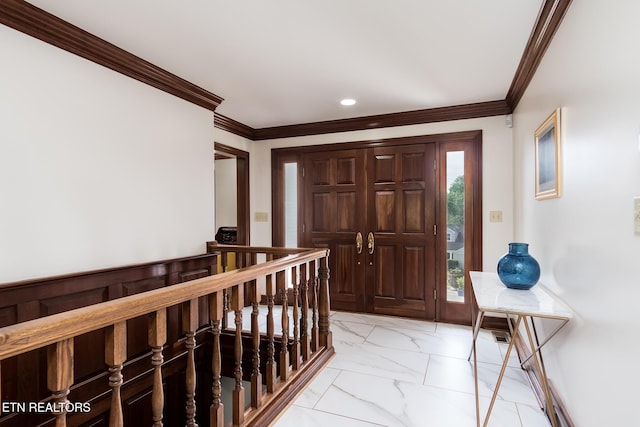 foyer entrance with recessed lighting, ornamental molding, and marble finish floor