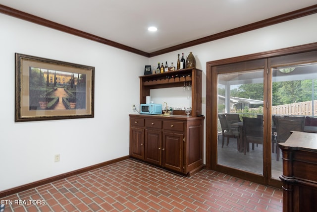 bar featuring ornamental molding, wet bar, brick floor, and baseboards