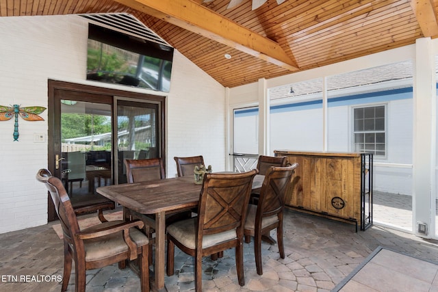 dining space featuring stone tile floors, high vaulted ceiling, beam ceiling, and wood ceiling