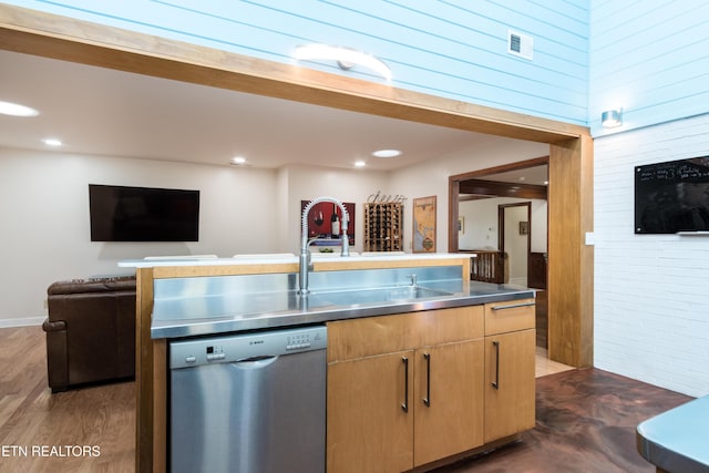 kitchen with stainless steel dishwasher, a sink, visible vents, stainless steel countertops, and open floor plan