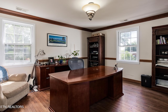 office space featuring visible vents, baseboards, ornamental molding, and wood-type flooring