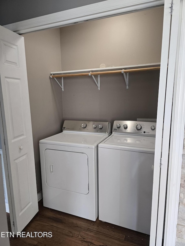 washroom featuring independent washer and dryer, laundry area, and dark wood-style flooring