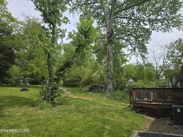 view of yard with a deck and a playground