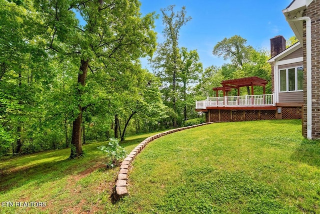view of yard with a deck and a pergola