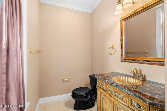 bathroom featuring vanity, tile patterned floors, toilet, baseboards, and ornamental molding