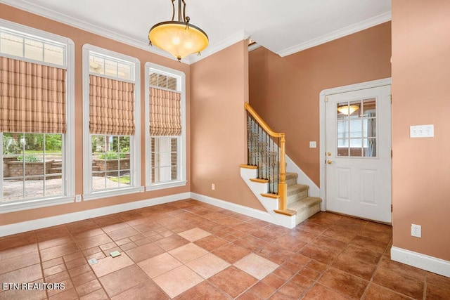 entrance foyer featuring ornamental molding, stairs, and baseboards