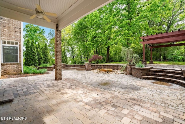 view of patio with ceiling fan and a pergola