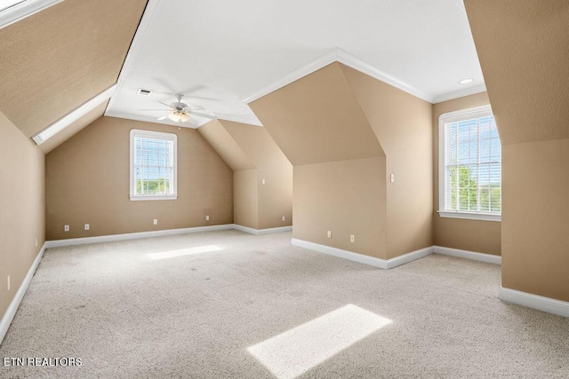 additional living space featuring baseboards, a ceiling fan, lofted ceiling, and carpet