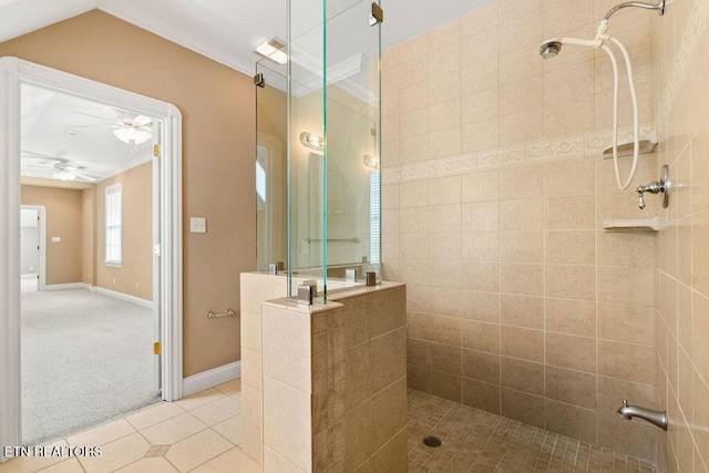 full bath featuring ceiling fan, a walk in shower, tile patterned floors, crown molding, and baseboards
