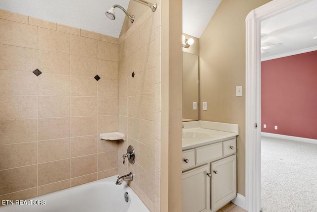 bathroom with baseboards, vanity, and  shower combination